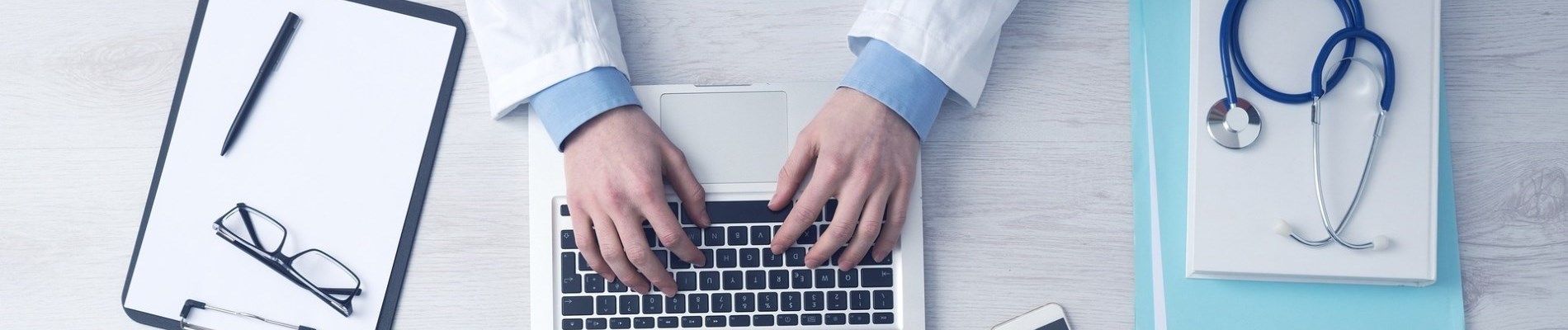 doctor entering data into a computer