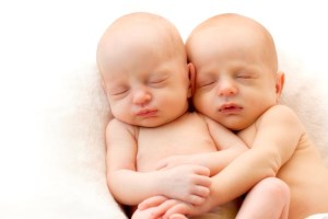 two newborn babies snuggling