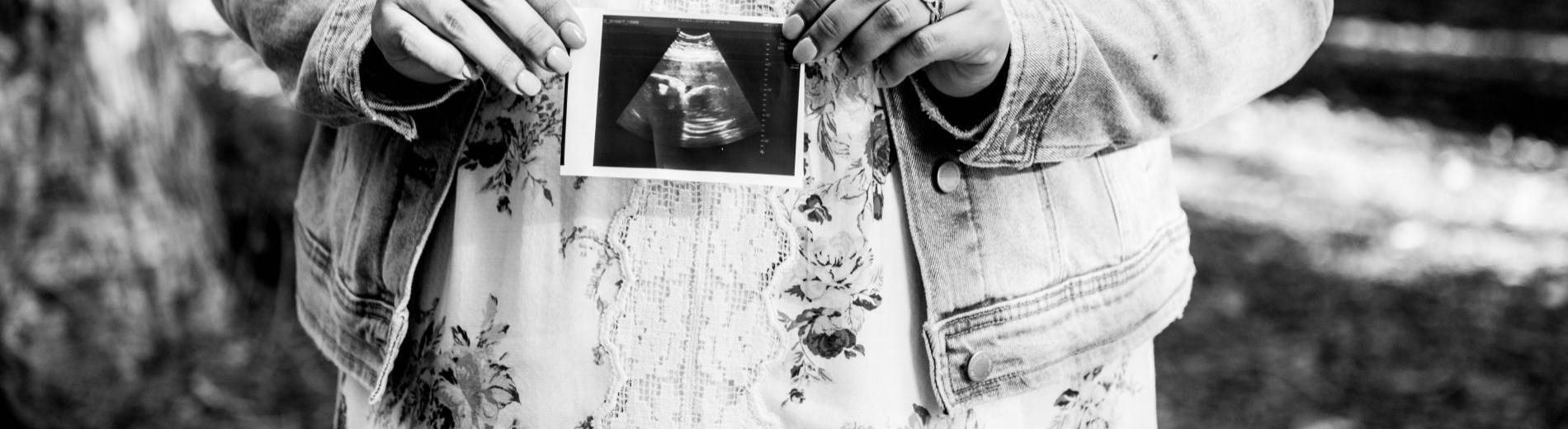 woman holding ultrasound picture