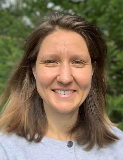 smiling woman with forest background