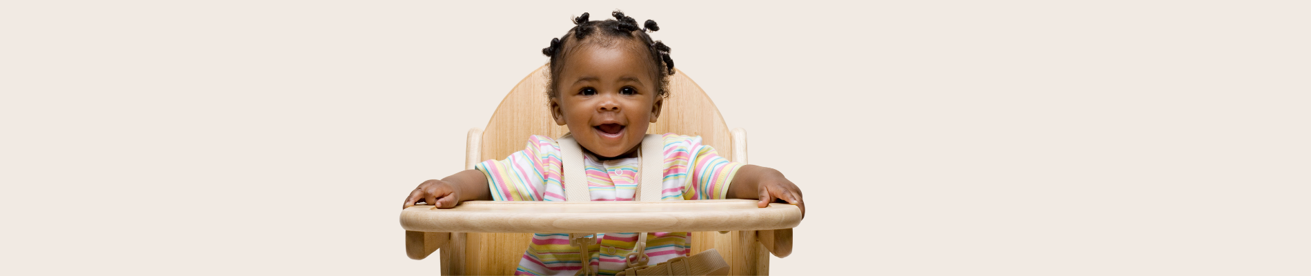 smiling baby in highchair