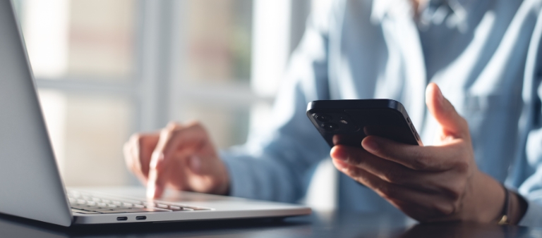 Woman tapping on her cell phone