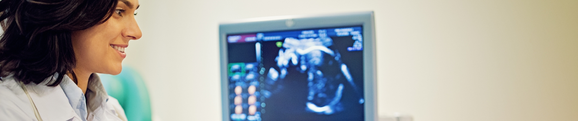 Doctor looking at sonograph screen