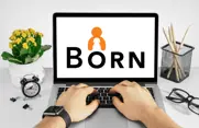 laptop with the BORN logo on the screen