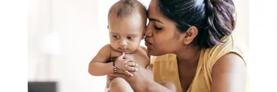 Mom kissing her baby