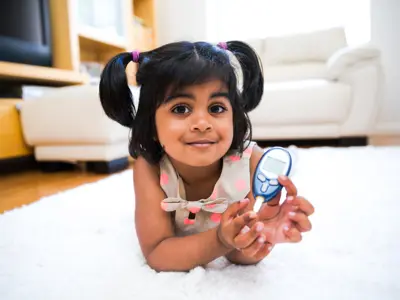 Little girl holding a glucometer